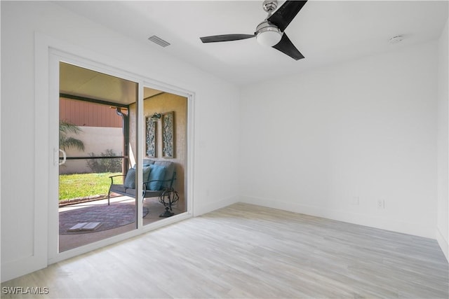 empty room with ceiling fan and light hardwood / wood-style floors