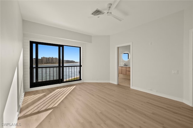 spare room featuring light wood-type flooring and ceiling fan