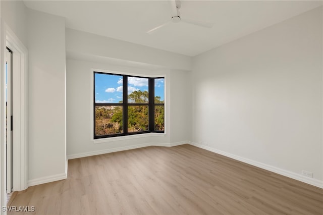 spare room featuring ceiling fan and light hardwood / wood-style flooring