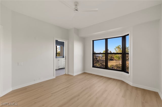 empty room with light wood-type flooring and ceiling fan