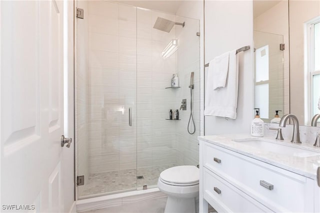 bathroom with vanity, toilet, and walk in shower