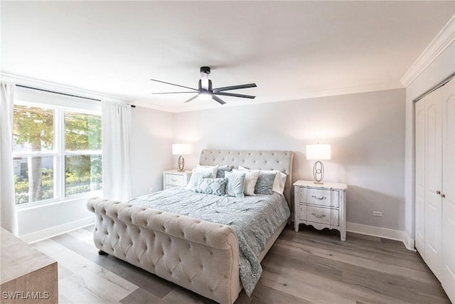 bedroom featuring a closet, hardwood / wood-style flooring, ceiling fan, and ornamental molding