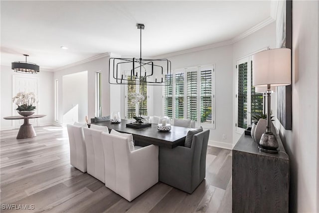 dining area featuring crown molding, an inviting chandelier, and hardwood / wood-style flooring