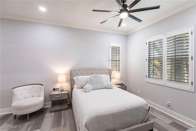 bedroom with hardwood / wood-style flooring, ceiling fan, and ornamental molding