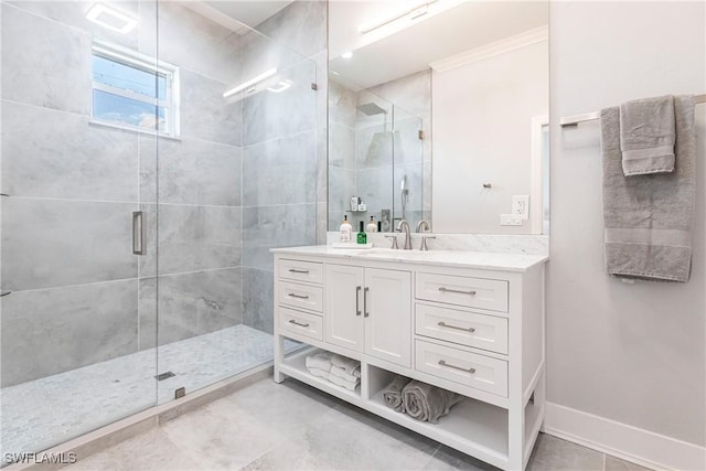 bathroom featuring a shower with door and vanity