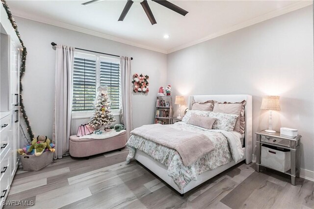 bedroom featuring ceiling fan, light hardwood / wood-style floors, and crown molding