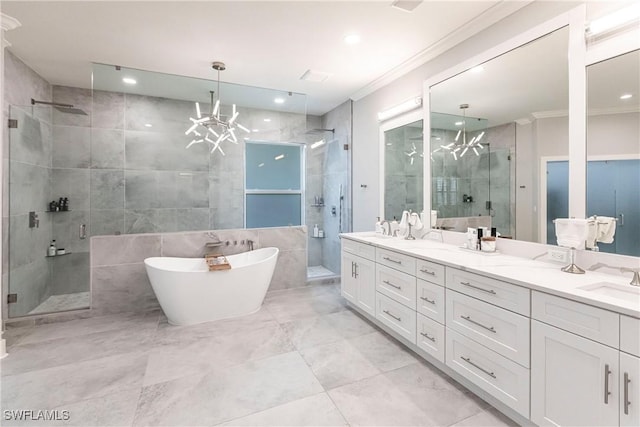 bathroom featuring an inviting chandelier, shower with separate bathtub, vanity, tile walls, and ornamental molding