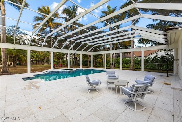 view of pool featuring an in ground hot tub, glass enclosure, and a patio area