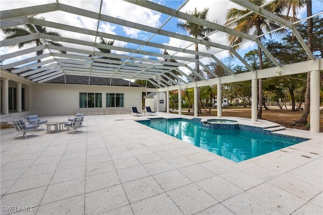 view of swimming pool featuring glass enclosure, a patio area, and an in ground hot tub