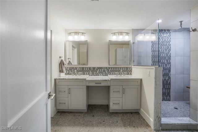 bathroom featuring backsplash, vanity, and tiled shower