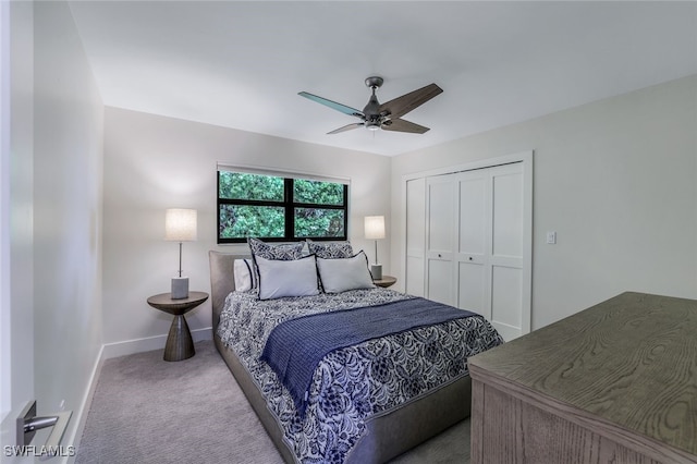 bedroom with ceiling fan, light carpet, and a closet