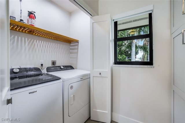 clothes washing area featuring independent washer and dryer