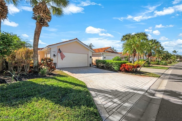 view of front of house with a front yard and a garage