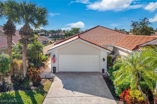 mediterranean / spanish-style home with a garage