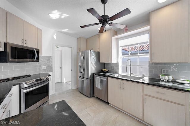 kitchen featuring backsplash, sink, light tile patterned floors, and stainless steel appliances