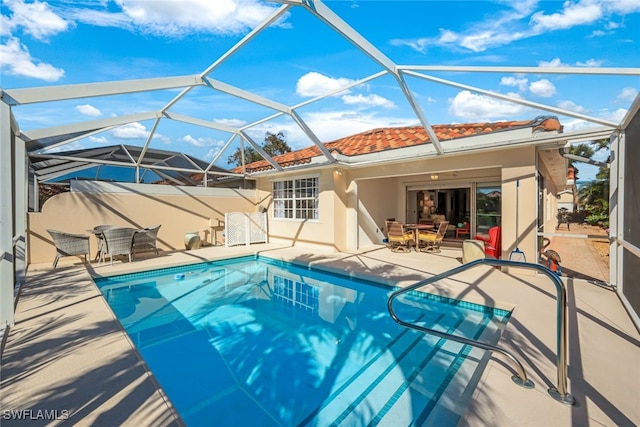 view of pool with a lanai and a patio