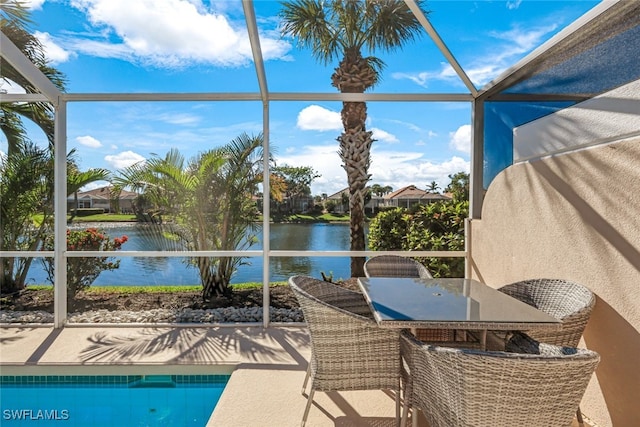 sunroom featuring a water view