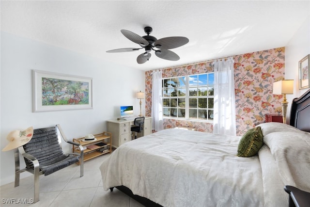 bedroom with light tile patterned floors, a textured ceiling, and ceiling fan