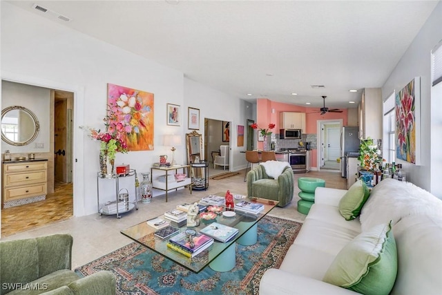 living area featuring a ceiling fan, visible vents, and recessed lighting