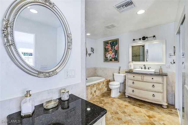 full bath featuring toilet, vanity, visible vents, recessed lighting, and tiled bath