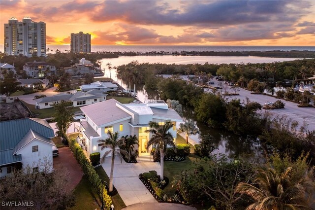 aerial view at dusk with a water view