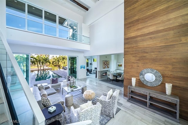 living area with wooden walls and a high ceiling