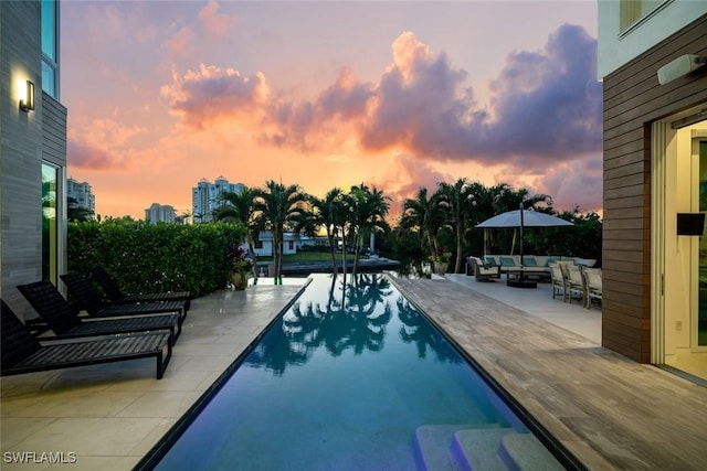 outdoor pool with an outdoor hangout area and a patio