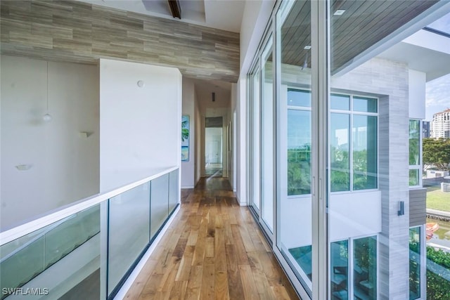 hallway featuring beamed ceiling and wood finished floors