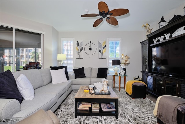 living room with wood-type flooring and ceiling fan