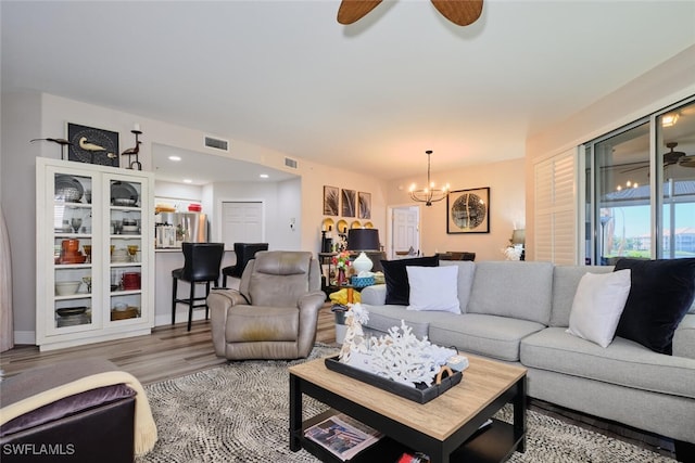 living room featuring a chandelier and hardwood / wood-style flooring