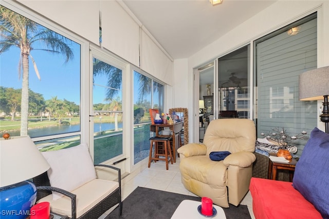 sunroom featuring a water view