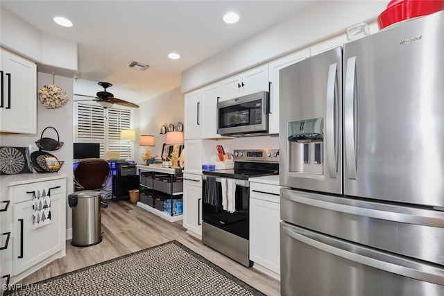 kitchen featuring white cabinetry, stainless steel appliances, and light hardwood / wood-style flooring