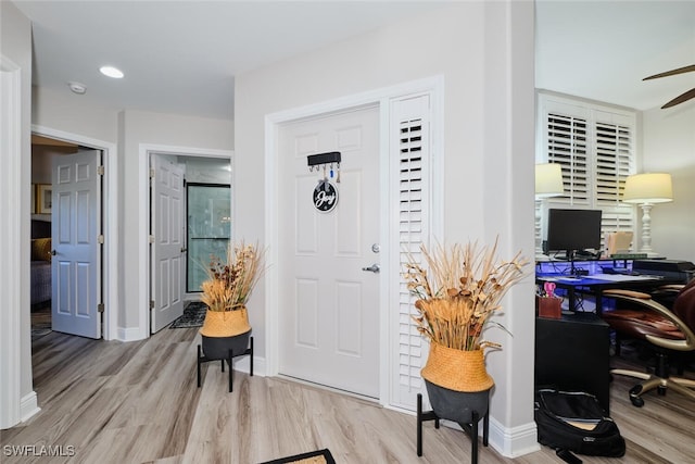 entryway with ceiling fan and light hardwood / wood-style floors