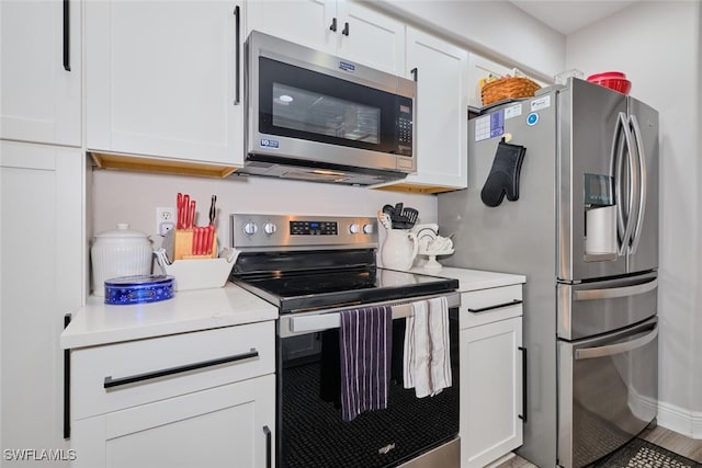 kitchen featuring white cabinets, hardwood / wood-style floors, and appliances with stainless steel finishes