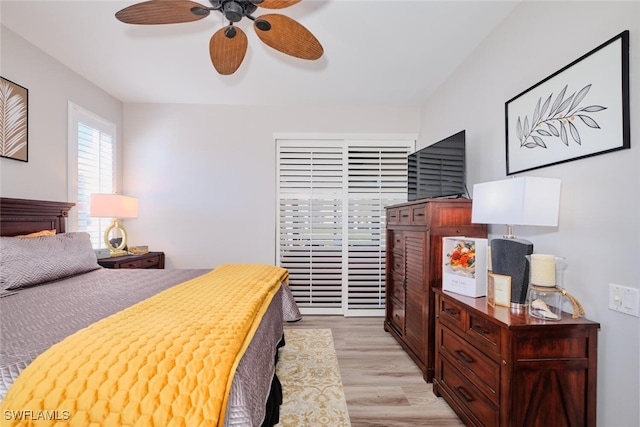 bedroom with light hardwood / wood-style flooring and ceiling fan