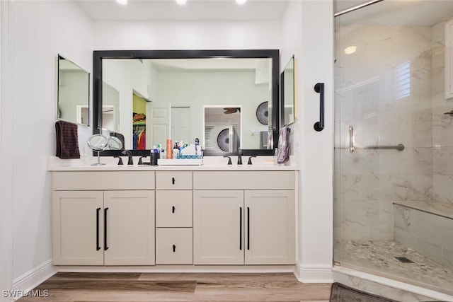 bathroom featuring vanity, hardwood / wood-style flooring, and walk in shower