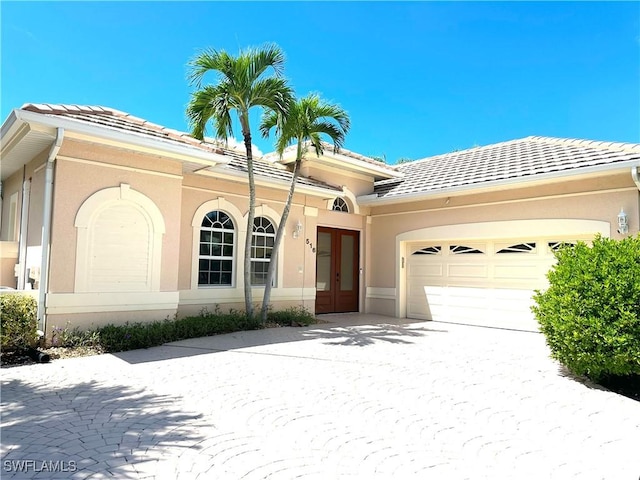 view of front facade featuring french doors and a garage