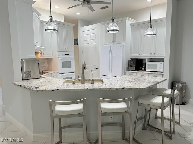 kitchen with white cabinetry, sink, decorative light fixtures, white appliances, and light tile patterned flooring