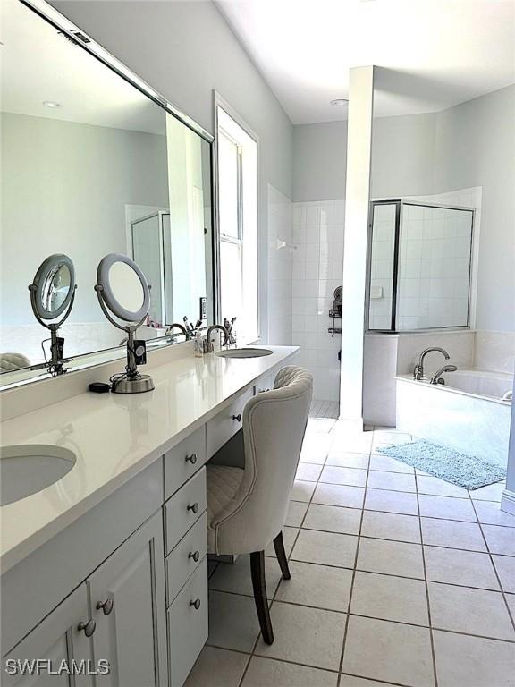 bathroom with tile patterned floors, vanity, and separate shower and tub