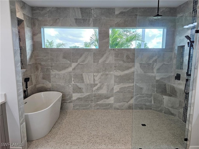 bathroom with vanity and shower with separate bathtub