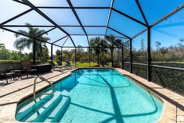 view of swimming pool with a patio area and a lanai