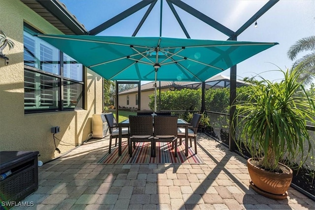 view of patio / terrace featuring glass enclosure