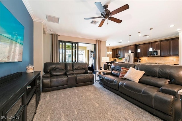 carpeted living room featuring ornamental molding and ceiling fan