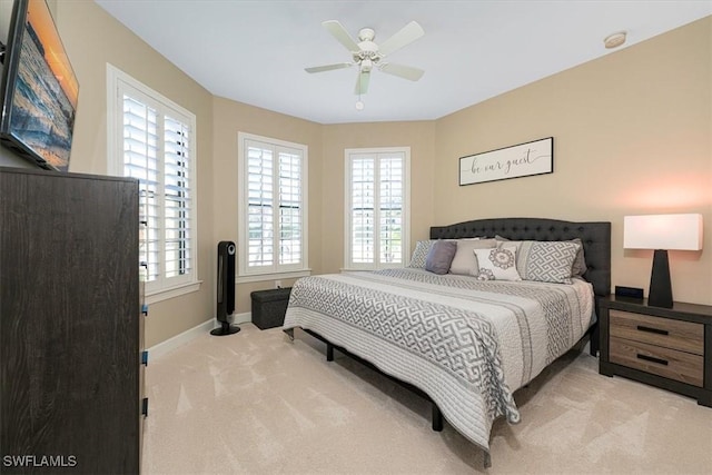 carpeted bedroom with multiple windows and ceiling fan