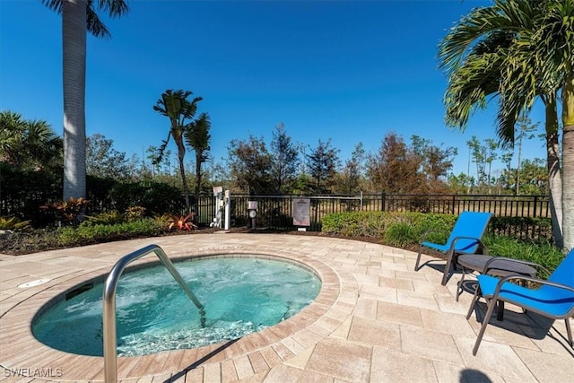 view of swimming pool with a patio area and a hot tub