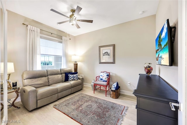 living room featuring ceiling fan and light hardwood / wood-style floors