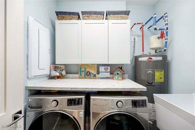 laundry area with cabinets, washing machine and dryer, electric water heater, and sink