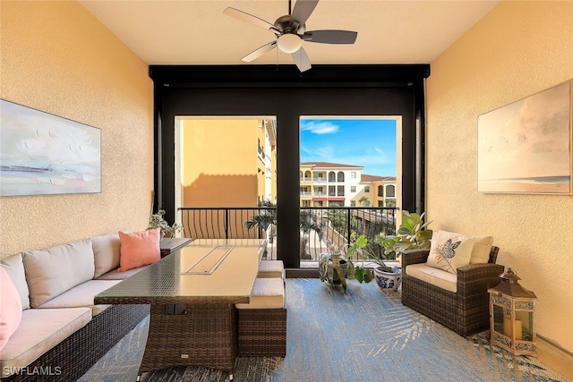 sunroom featuring ceiling fan