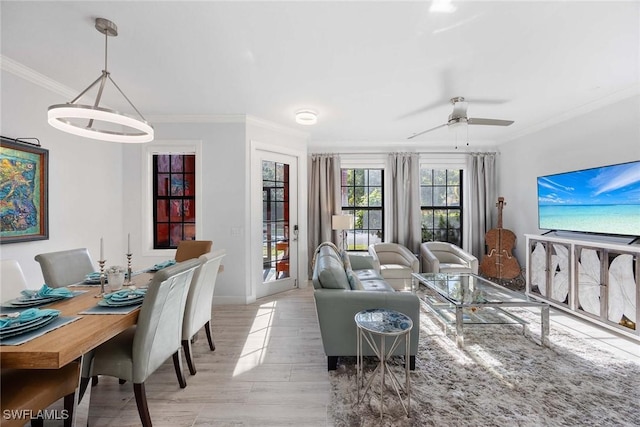 living room with ceiling fan, light wood-type flooring, and crown molding