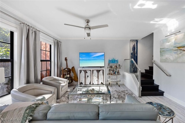 living room featuring ceiling fan, crown molding, and light hardwood / wood-style floors